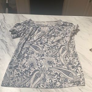 A white blouse with a nice blue pattern.